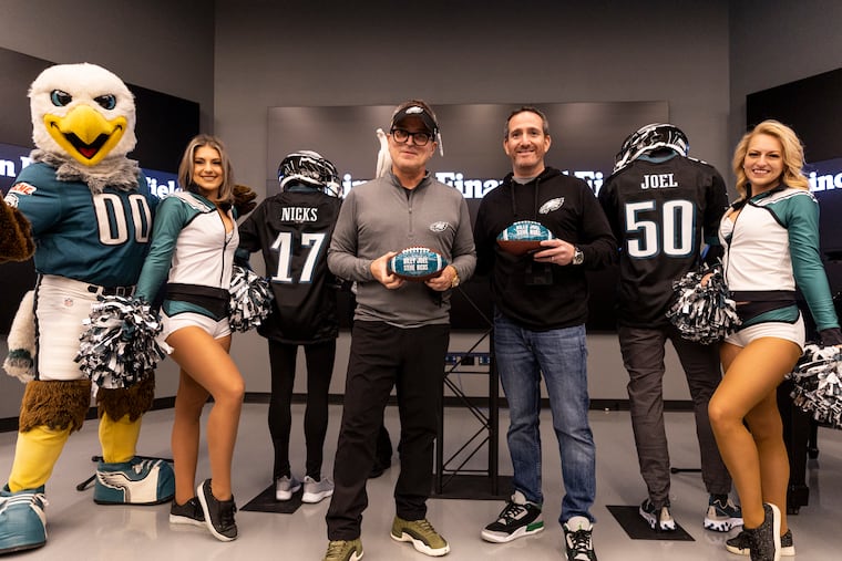 Geoff Gordon, regional president at Live Nation Entertainment, and Howie Roseman, Philadelphia Eagles general manager, pose for a group photo after the announcement of Billy Joel and Stevie Nicks show at the Lincoln Financial Field at a news conference in Philadelphia on Thursday Dec. 8, 2022.