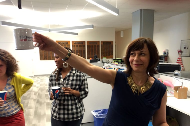 Celebrating with a cup of champagne, Philadelphia Inquirer architecture critic Inga Saffron addresses the newsroom after winning the Pulitzer Prize for criticism Monday, April 14, 2014. In its citation, the Pulitzer Committee cited Saffron, a previous finalist for the award, "for her criticism of architecture that blends expertise, civic passion and sheer readability into arguments that consistently stimulate and surprise." Michael Mercanti / Staff
