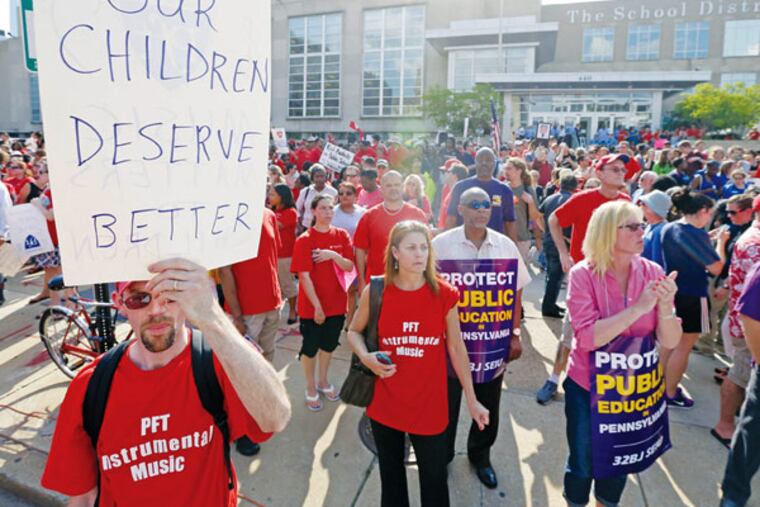 Demonstrators protest outside the school district headquarters, Thursday, May 30, 2013, in Philadelphia. (AP Photo/Matt Rourke)
