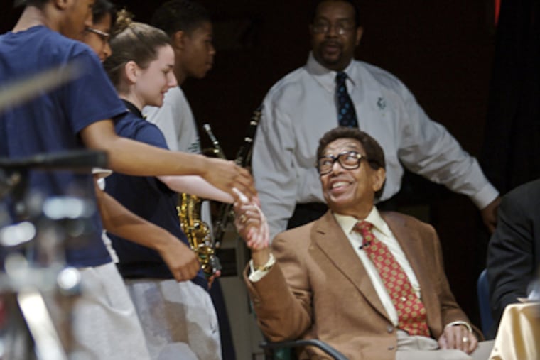Jazz musician Billy Taylor shakes hands and has words of encouragement for the students of the Girard Academic Music Program at 22d and Ritner Streets in South Philadelphia. (John Costello / Staff Photographer)