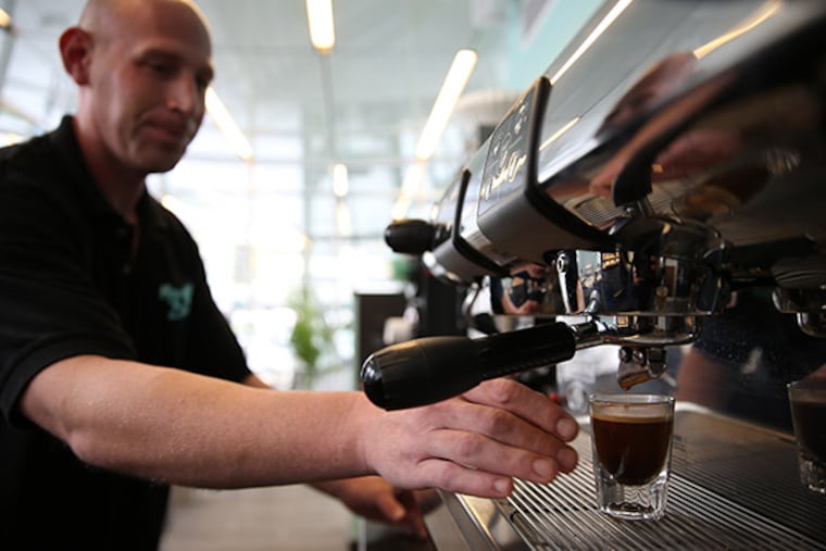 Avery Kessler pulls a shot of espresso for a Cafe Cubano at Rosa Blanca Cafe on Dilworth Park in Philadelphia on September 23, 2014. ( DAVID MAIALETTI / Staff Photographer )