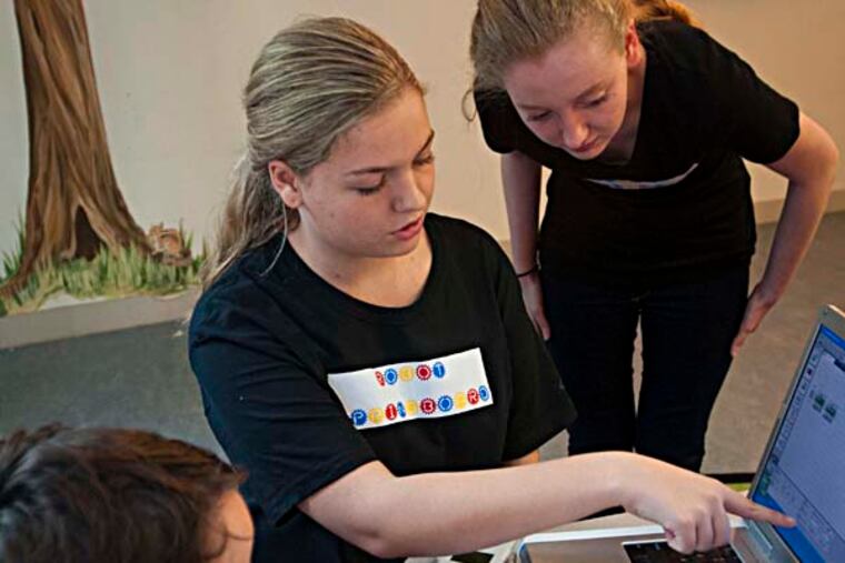 Rachael (left) and Hannah Tipperman teach robotics to a class of 4th and 5th grader at the Tredyffrin Public Library.The twins from Devon started their own nonprofit in 2012 to develop robotics programs for grade school kids. ( RON TARVER / Staff Photographer ) July 22 2014