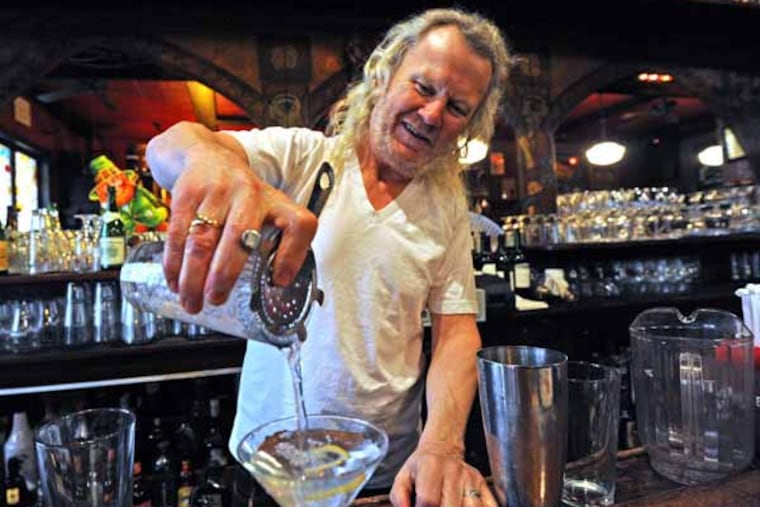 At his bar, Fergie's Pub, Fergus Carey makes, shakes and drinks a martini and relaxes with customers on March 22, 2013. ( APRIL SAUL / Staff )