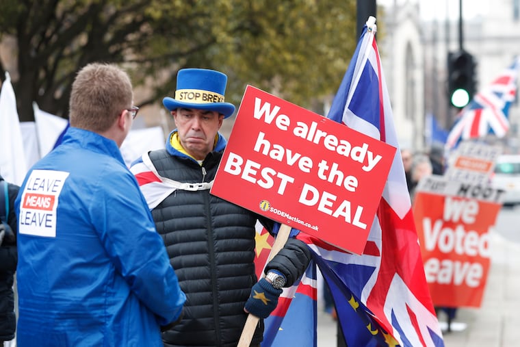 Pro-Brexit (left) and anti-Brexit (right) protesters debate their views outside parliament in London last week.