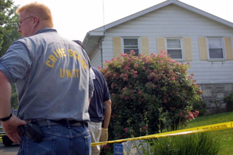 Crime scene investigators outside Springfield Township home of Chineta Glanville after she and her godson were shot to death in 2002. File photo. (Special to the Daily News/Mark Ludak)
