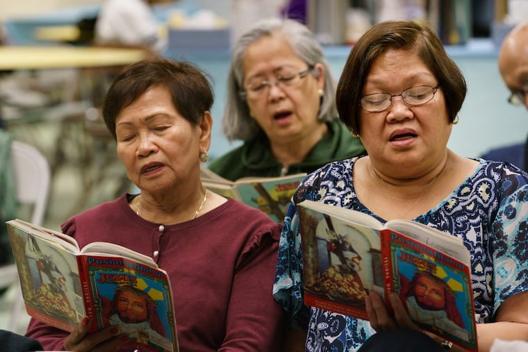 (Left to Right) Reme Cargado, Evangeline Kalugdan (back center), and Violy David sing at the Social Hall of Our Lady of Hope Catholic Parish in North Philadelphia. Filipino Catholics celebrate Good Friday by spending all day, from dawn to till dusk, singing a Tagalog religious text about the life of Jesus Christ.
