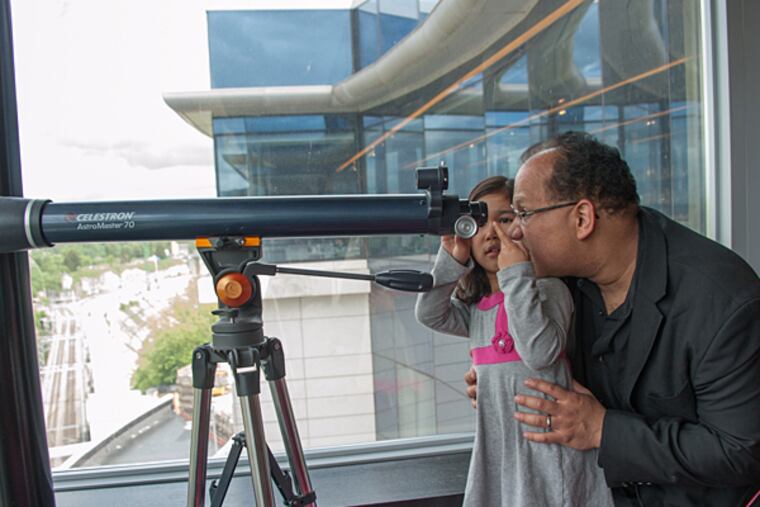 At the hotel, Philadelphia Orchestra principal clarinetist Ricardo Morales and daughter Victoria peer over Luxembourg. (Photo credit: Jan Regan / Philadelphia Orchestra)