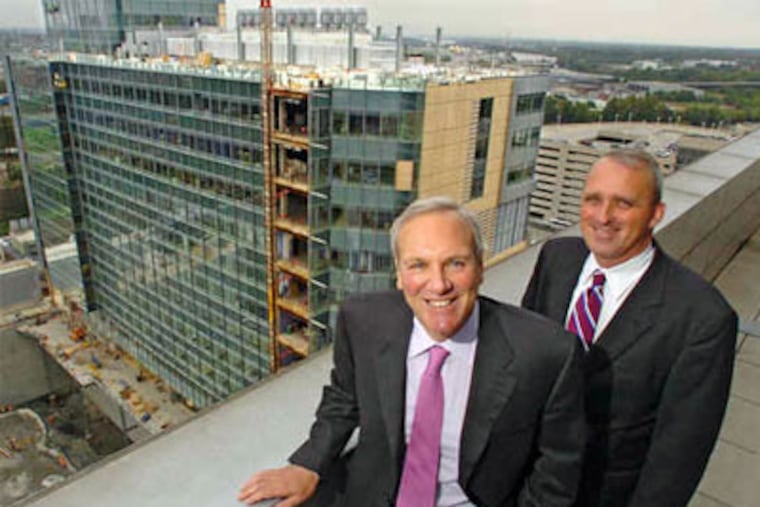 Senior executives Steven Altschuler (left) and Stuart Sullivan, overlooking the new Colket Translational Research Building. (Clem Murray / Staff Photographer)
