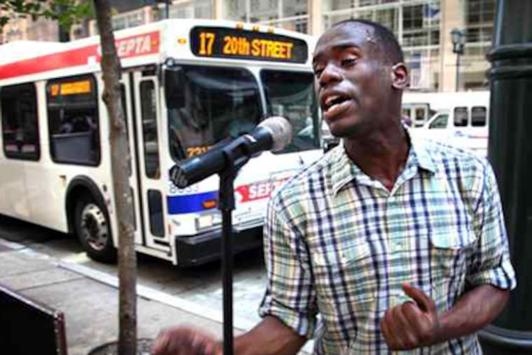 Anthony Riley, performing on Market Street, reached a settlement after his 2007 disorderly-conduct arrest for singing in Rittenhouse Square was deemed wrong. On Tuesday, he will audition for "American Idol." (Laurence Kesterson / Staff Photographer)