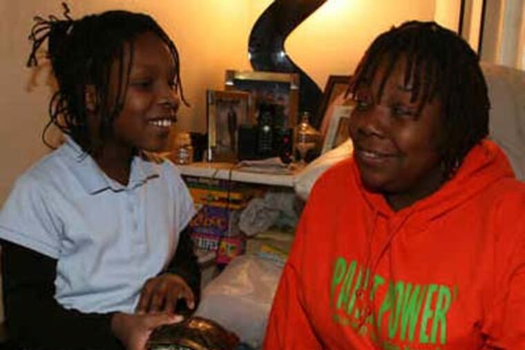 Sylvia Simms, with her granddaughter, founded Parent Power to get parents more involved with kids' education. (Jimmy Viola / Staff Photographer)