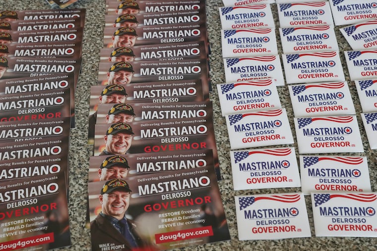 Campaign items for Pa. State Sen. Doug Mastriano, Republican nominee for governor, sit outside of Gatsby's Bar & Grill where he spoke to supporters in Aston, Pa. on Aug. 24.