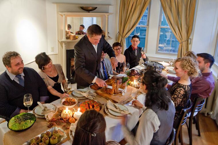 Chef Townsend "Tod" Wentz carves the turkey at the Thanksgiving preview dinner for staff and guests at Townsend, his six-month-old restaurant on East Passyunk Avenue. He's cooking two more Thanksgiving dinners: A buffet for Townsend's customers on Tuesday, and the real thing for his family. (DAVID M WARREN / Staff Photographer)