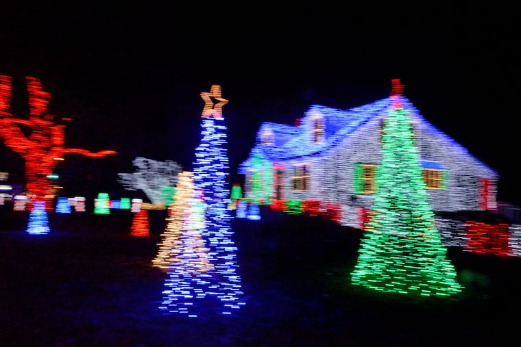 "One of the things I enjoy is helping people," Amber Merefield says. "People really enjoy it, and it has become a special part of their holiday tradition." (A slow camera shutter speed blurs the lights.)