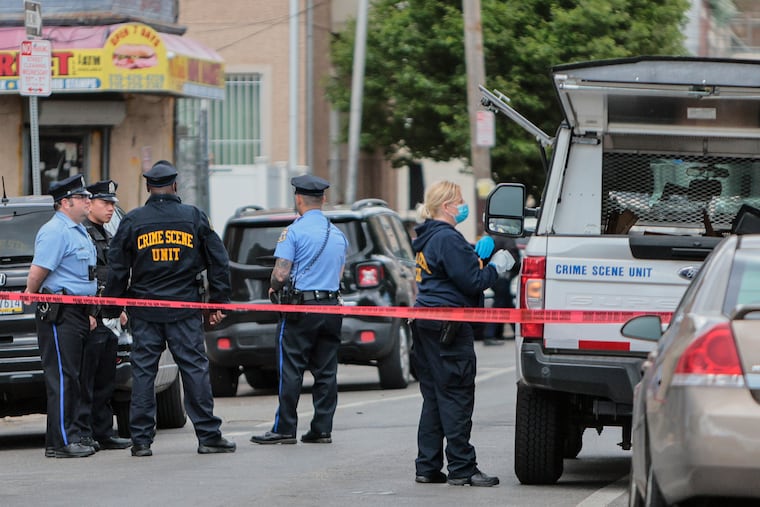 Police holding the crime scene in the 2200 block of North Camac Street, where officers fatally shot a man Thursday.