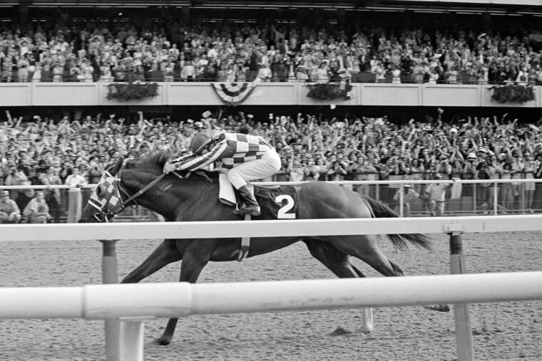 Ron Turcotte hangs on as Secretariat romps along the final stretch just before the finish line and a victory in the 105th running of the Belmont Stakes on June 9, 1973.