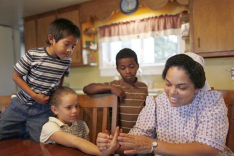 Autumn Stauffer with (from left) Rolando, Lanita, and Malachi. She and her white husband are raising their five biological, one adopted and two foster children. (Michael S. Wirtz / Staff Photographer)