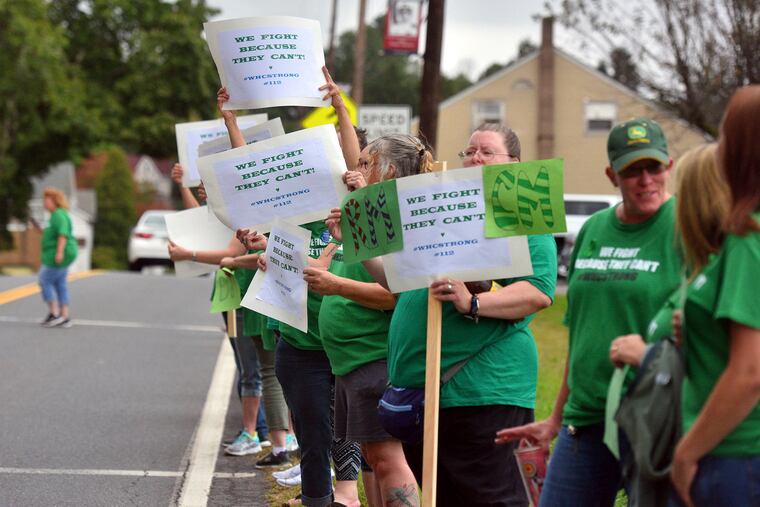 Family members of White Haven Center residents line Church Road to rally against the closing of the facility, Thursday, Sept. 12, 2019 in White Haven, Pa.