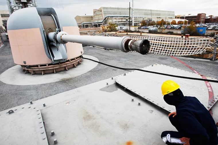 A gun mounted on the deck will be salvaged. The Navy is paying Philadelphia Ship Repair to salvage parts from decomissioned frigates. They begin with parts from the decomissioned USS Hawes FFG53 in dry dock at the Philadelphia Navy Yard. November 26, 2013.( MICHAEL S. WIRTZ / Staff Photographer)