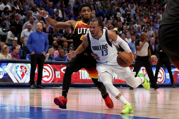 Jalen Brunson drives to the basket against the Utah Jazz' Donovan Mitchell during the NBA playoffs.