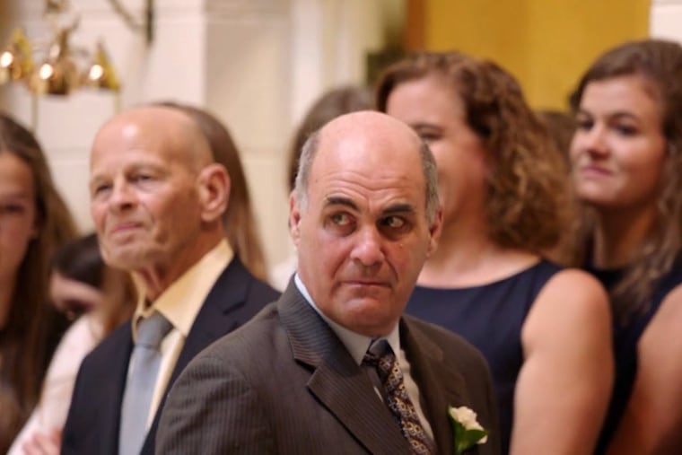 Villanova women's basketball coach Harry Perretta walks away after being allowed to hug Shelly Pennefather, his former star player, for the first time in 25 years.