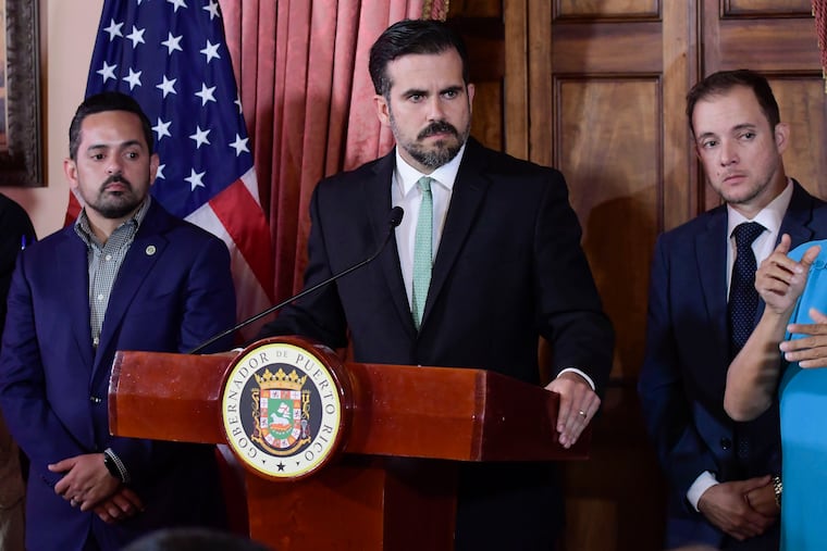 Puerto Rico Gov. Ricardo Rosselló (center) said Friday that he was resigning as promised and swearing in veteran politician Pedro Pierluisi as his replacement, a move certain to throw the U.S. territory into a period of political chaos.