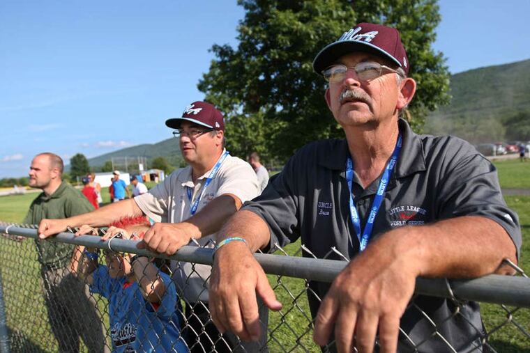 Team Uncle's Bruce Sechrist, right, and Pete Lupacchino, right, lean on the chain link fence of Field C and watch their Taney take batting practice Monday afternoon. Taney Little League practices on Tuesday afternoon for their game against Las Vegas Wednesday night. ( MICHAEL BRYANT / Staff Photographer )