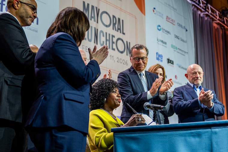 Mayor Cherelle L. Parker with an executive order she signed following her keynote address at the Chamber of Commerce for Greater Philadelphia’s annual mayoral luncheon.