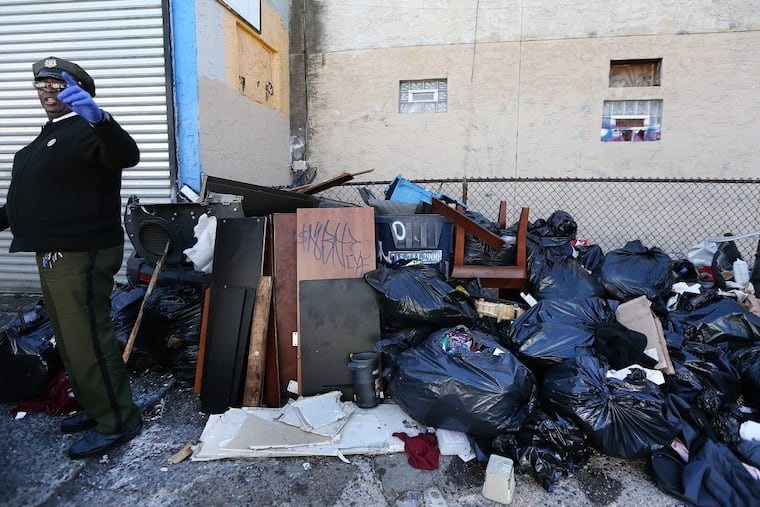 Sanitation enforcement officers investigate when residents complain to the city’s 311 hotline about trash. In this photo from October 2017, supervisor Willie Hamilton inspects a pile of trash along the 3200 block of Jasper Street in Kensington.