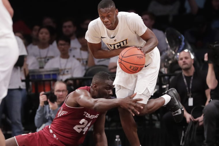 Virginia Commonwealth's De'Riante Jenkins, top, drives past Temple's Ernest Aflakpui (24) during the first half of an NCAA college basketball game in the Legends Classic tournament Monday, Nov. 19, 2018, in New York. (AP Photo/Frank Franklin II)