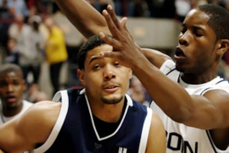 Villanova guard Scottie Reynolds moves around UConn's Jerome Dyson during the first half. Reynolds' 40 points - more than half of the team's total - broke a freshman school record set in 1978. But his fouling out, he said after the game, encouraged by coach Jay Wright, was "kind of stupid."