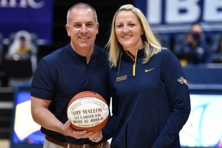 Nick Gannon, Drexel's deputy athletic director, celebrates with women's basketball coach Amy Mallon after her first victory as Dragons head coach.