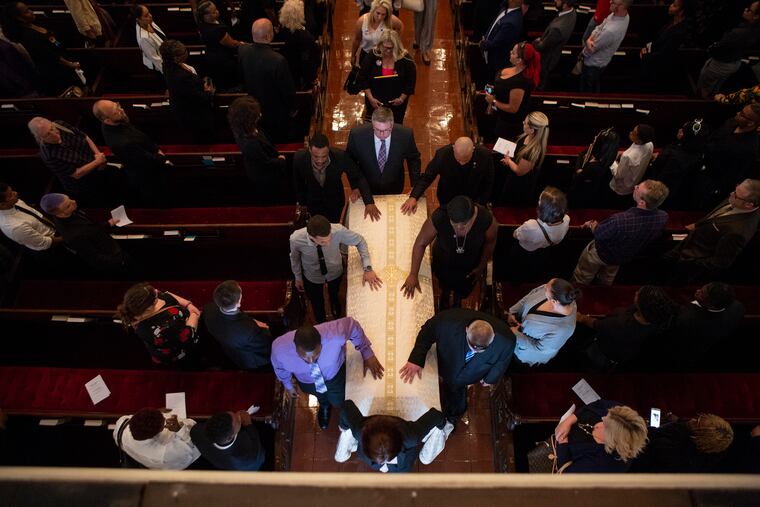 The casket of Deputy Sheriff Dante Austin is brought out of the Church of Saint Luke and The Epiphany after his funeral service in Philadelphia Saturday.