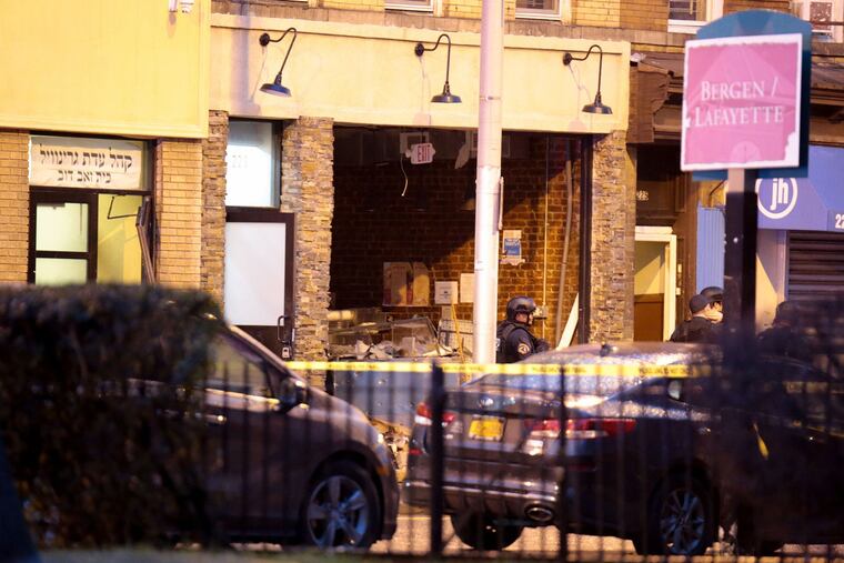 A kosher grocery store with its front blown out is seen in Jersey City after a couple opened fire inside, killing at least three people on Tuesday, Dec. 10, 2019.