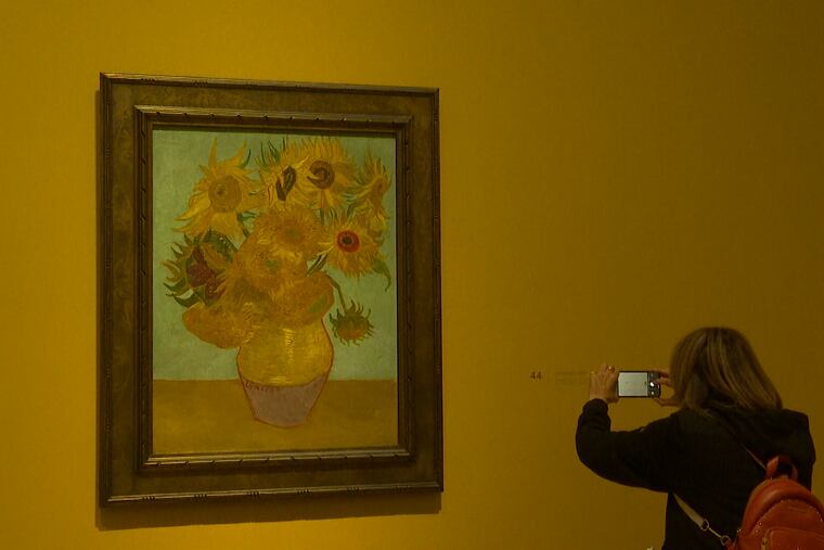 Woman of Vincent Van Gogh's iconic "Sunflowers" (the version from the Philadelphia Museum of Art) now on display at London's National Gallery.