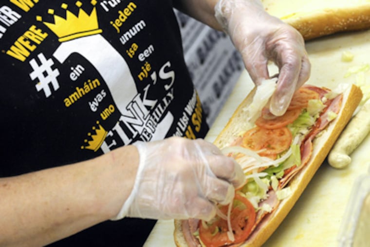 File photo of Karen Williams preparing a hoagie at Fink's. (TOM GRALISH / Staff Photographer)