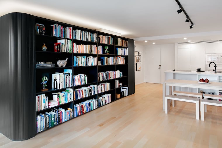Olivia Walling hired architect Chris Greenawalt of Bunker Workshop and contractor Vincent Novello to open up and reimagine her 850-square-foot space. In the center, they built a pod around an existing structural column that houses Walling's extensive book collection, a coat closet, art supply storage, and an alcove bed.