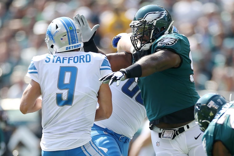 Eagles defensive tackle Fletcher Cox (91) can't get his hands on Detroit Lions quarterback Matthew Stafford as he is blocked by center/guard Graham Glasgow (60).