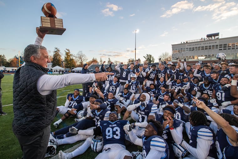Coach Mark Ferrante holds up the trophy after Villanova beat Delaware, 38-28, in the Battle of the Blue on Nov. 23.
