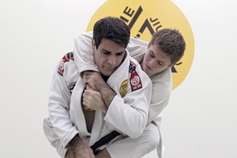 Brian Rago (left) and Zak Maxwell go through a routine. "In jujitsu, we're not trying to hurt each other,” Rago says. "We're trying to improve with each other." (Ron Cortes / Staff Photographer)