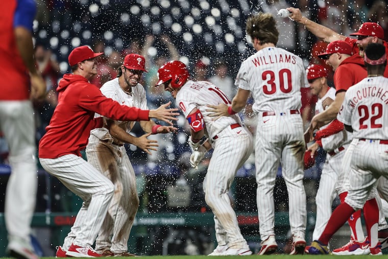 Phillies catcher J.T. Realmuto (10) celebrates with teammates after his walk-off, two-run triple beat the Orioles in the 10th inning at Citizens Bank Park.
