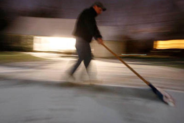 Jack Harkins shovels the snow from his sidewalk and driveway in the Barclay Farms section of Cherry Hill on Thursday. (Elizabeth Robertson / Staff Photographer)