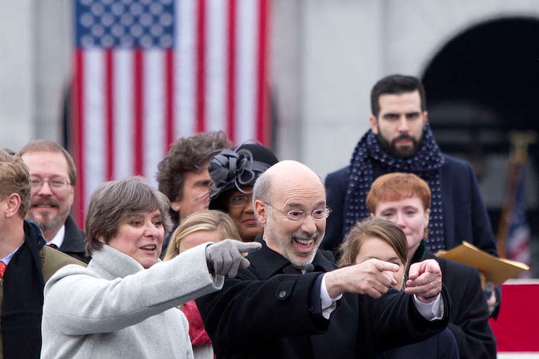 Gov. Wolf and his wife, Frances, point and wave to someone they know in the crowd at his first inauguration in 2015.