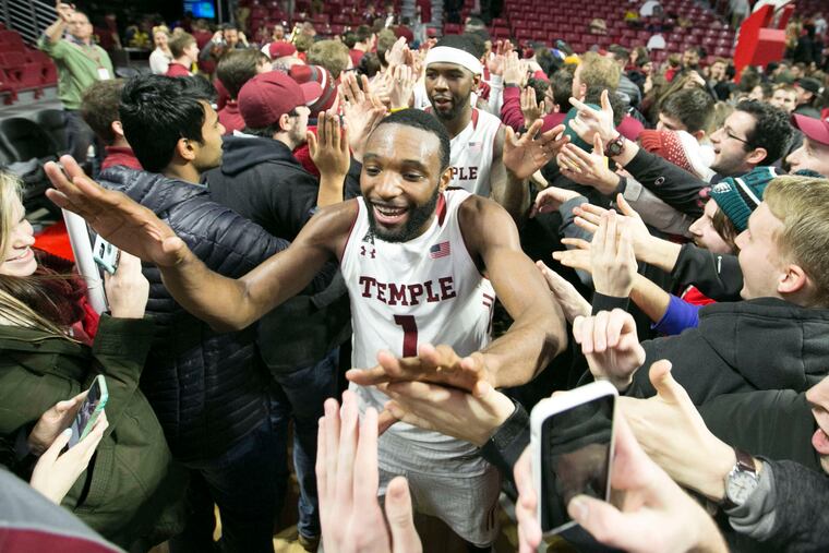 Temple's Josh Brown (1) and Mark Williams make their way through the crowd after the Owls defeated No. 8 SMU.