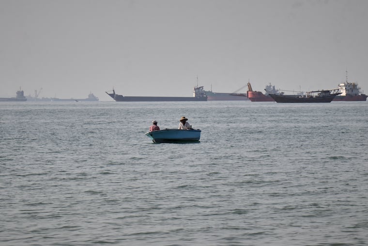 Bulk carriers, cargo ships, and service vessels line the horizon in the Strait of Hormuz off Bandar Abbas, Iran, Monday, April 27, 2026.
