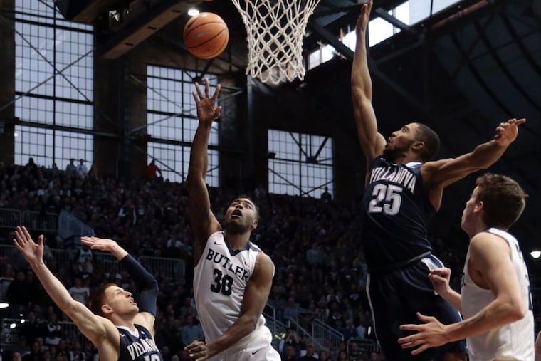 Butler forward Kelan Martin (30) shoots between Villanova defenders Donte DiVincenzo (10) and Mikal Bridges (25) in the first half of an NCAA college basketball game in Indianapolis, Saturday, Dec. 30, 2017.