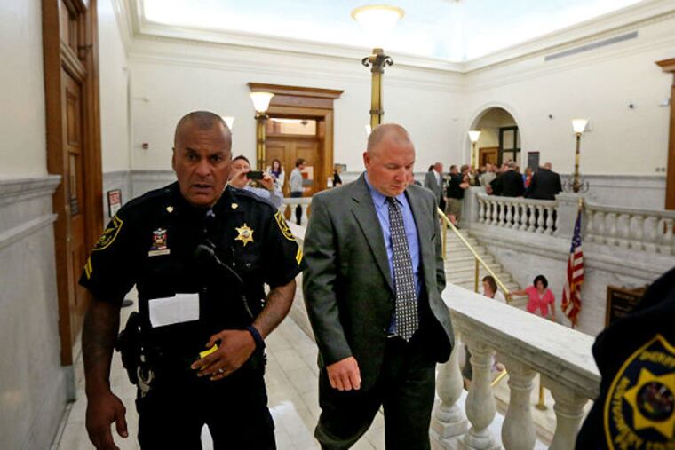 Former Pennsylvania State Trooper Richard Schroeter (right) is escorted from the Montgomery
County Courthouse after being sentenced. (DAVID SWANSON/Staff Photographer)