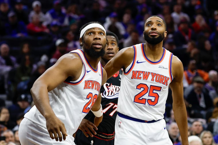 Knicks forward Guerschon Yabusele (left) and guard Mikal Bridges box out Sixers guard VJ Edgecombe in Saturday's game. The Knicks narrowly won, 112-109.