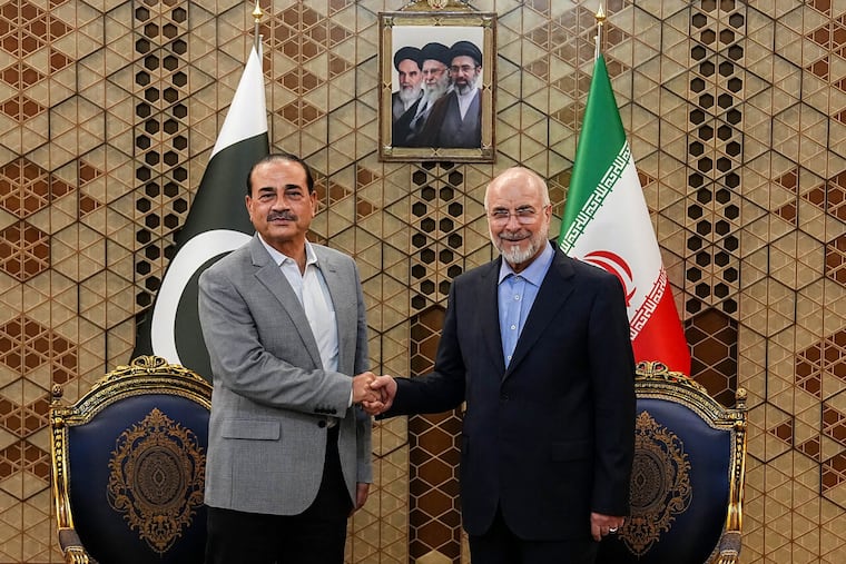 Iran's Parliament Speaker Mohammad Bagher Qalibaf, right, shakes hands with Pakistan's Army Chief Field Marshal Gen. Asim Munir during their meeting in Tehran, Iran, Sunday, May 23, 2026.