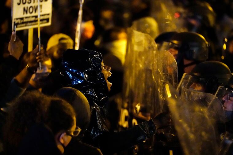 Protestors confront police during a march Tuesday Oct. 27, 2020 in Philadelphia. Hundreds of demonstrators marched in West Philadelphia over the death of Walter Wallace, a Black man who was killed by police in Philadelphia on Monday. Police shot and killed the 27-year-old on a Philadelphia street after yelling at him to drop his knife. (AP Photo/Matt Slocum)