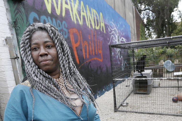 Saudia Shuler and the black leopard at the Wakanda-themed prom send off on 22nd St. in North Phila., Pa. on June 6, 2018.